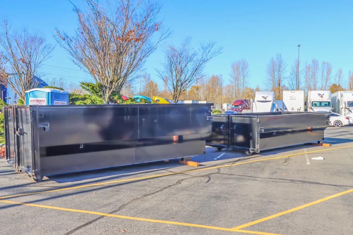 Professional dumpster rental service with roll-off container on residential driveway in Riverview